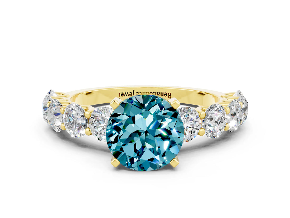 Yellow gold Round Cut Blue Topaz Prong Setting with Side Stones on a Pave Band