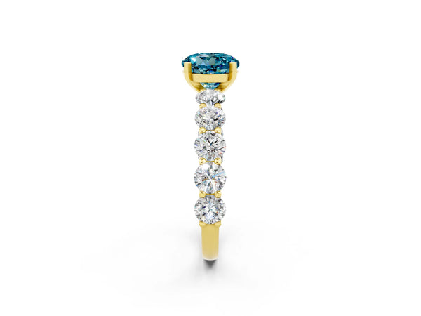Yellow gold Round Cut Blue Topaz Prong Setting with Side Stones on a Pave Band