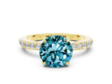 Yellow gold Round Cut Blue Topaz Solitaire Engagement Ring with Pavé Band and Four-Prong Setting