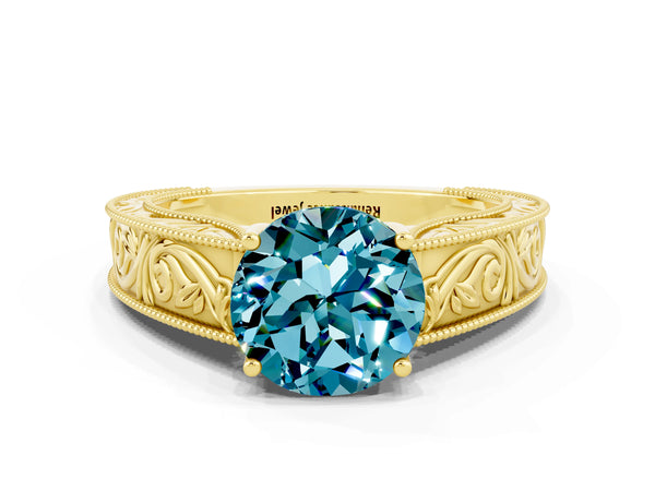 Yellow gold Round Cut Blue Topaz Solitaire Ring with Engraved Band and Four-Prong Setting