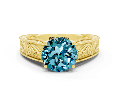 Yellow gold Round Cut Blue Topaz Solitaire Ring with Engraved Band and Four-Prong Setting