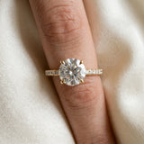 Yellow gold Round Cut Diamond Brilliant Solitaire Ring with Pavé Band and Four-Prong Setting