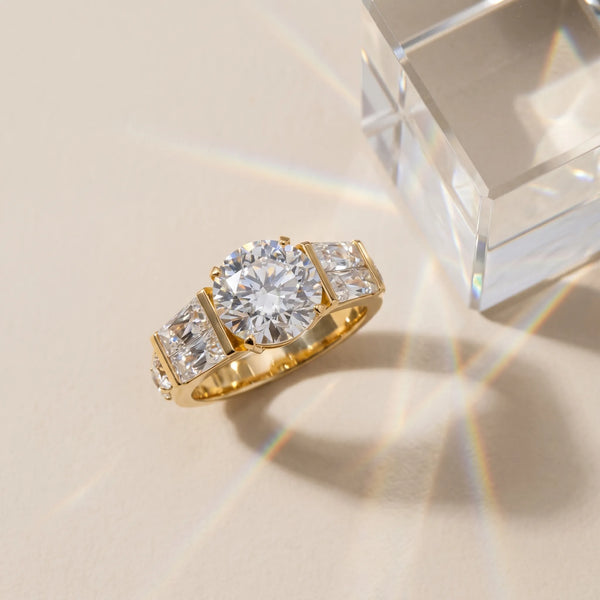 Yellow gold Round Cut Diamond Engagement Ring with Baguette Side Stones and Channel Set Band