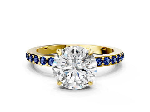 Yellow gold Round Cut Diamond Pavé Engagement Ring with Round with Blue Sapphire side stone Accents and Prong Setting