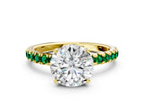 Yellow gold Round Cut Diamond Pave Band Solitaire Ring with Round with Emerald side stone and Prong Setting