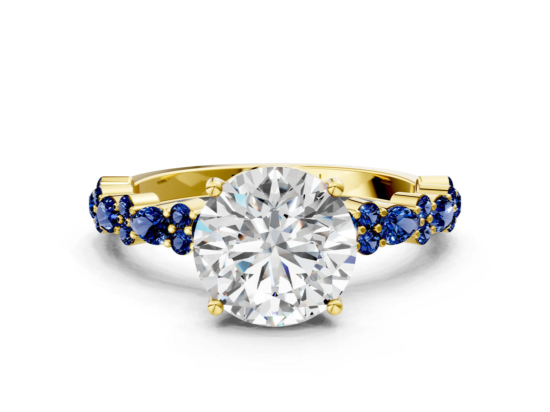 Yellow gold Round Cut Diamond Side Stone Solitaire Ring with Round with Blue Sapphire side stone and Four-Prong Setting