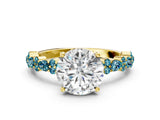 Yellow gold Round Cut Diamond Side Stone Solitaire Ring with Round with Blue Topaz side stone and Four-Prong Setting