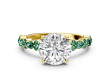 Yellow gold Round Cut Diamond Side Stone Solitaire Ring with Round with Green Sapphire side stone and Four-Prong Setting