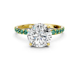 Yellow gold Round Cut Diamond Solitaire Ring with Round with Green Sapphire side stone Pavé Band and Prong Setting