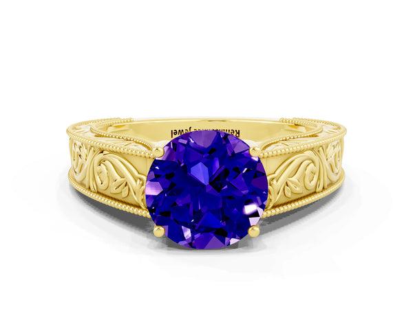 Yellow gold Round Cut Tanzanite Solitaire Ring with Engraved Band and Four-Prong Setting