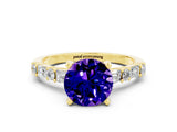 Yellow gold Round Cut Tanzanite Solitaire with Side Baguettes and Channel Set Band