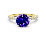 Yellow gold Round Cut Tanzanite Solitaire with Side Stones on a Pavé Band and Four-Prong Setting