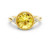 Yellow gold Round Cut Yellow Sapphire Halo Ring with Tapered Band and Four-Prong Setting
