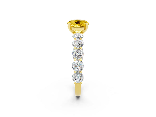Yellow gold Round Cut Yellow Sapphire Prong Setting with Side Stones on a Pave Band