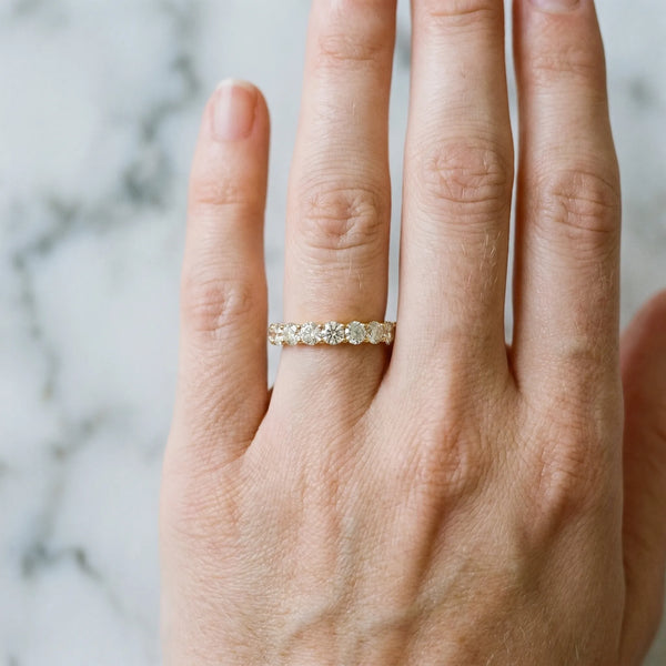 Yellow gold Round Diamond Eternity Band with Pavé Setting and Shared Prong