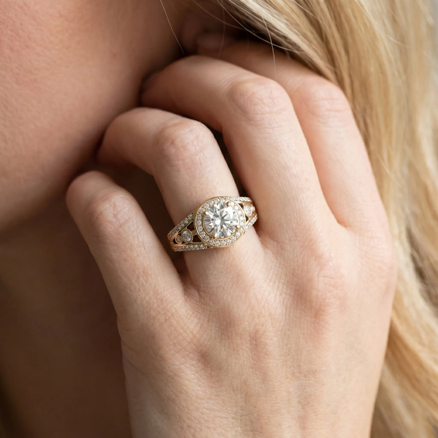 Yellow gold Round Diamond Halo Ring with Split Shank and Bezel Accents and Four-Prong Setting