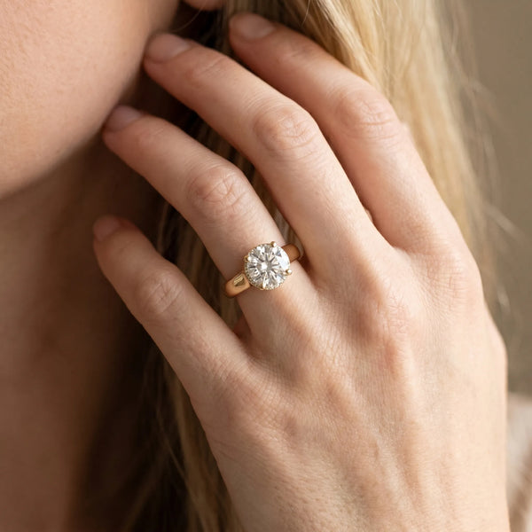 Yellow gold Round Solitaire Diamond Engagement Ring with Four-Prong Setting and Tapered Band