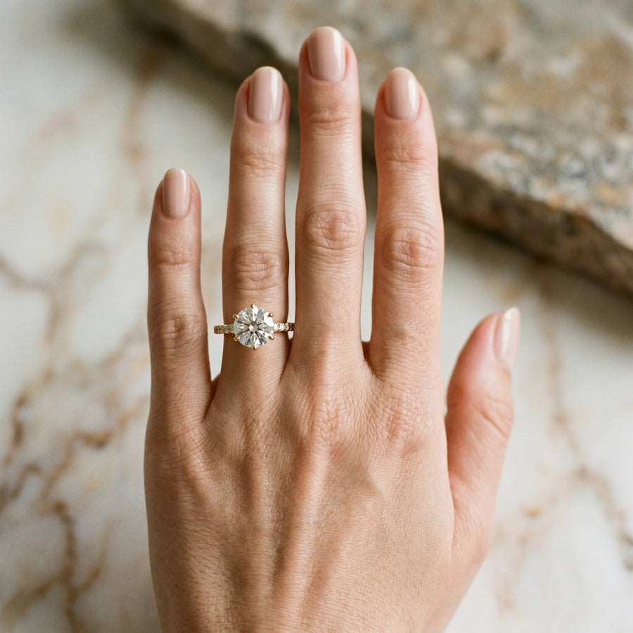 Yellow gold Round Solitaire Diamond Engagement Ring with Pavé Band and Six-Prong Setting