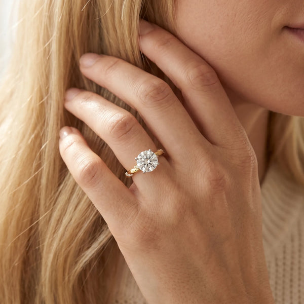 Yellow gold Round Solitaire Diamond Engagement Ring with Twisted Pave Band and Four-Prong Setting