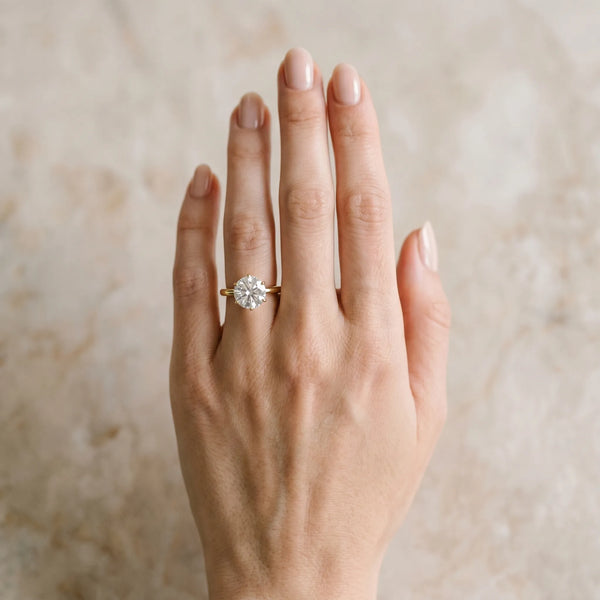 Yellow gold Round Solitaire Diamond Ring with Six-Prong Setting on a Classic Band