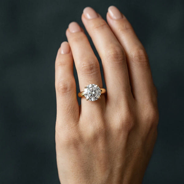 Yellow gold Round Solitaire Diamond Ring with Tapered Band and Four-Prong Setting