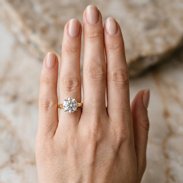 Yellow gold Round Solitaire Engagement Ring with Four-Prong Setting and Tapered Band