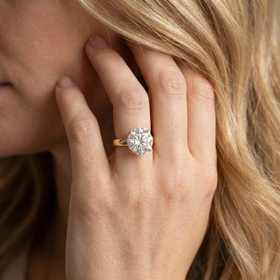 Yellow gold Round Solitaire Engagement Ring with Four-Prong Setting and Tapered Band