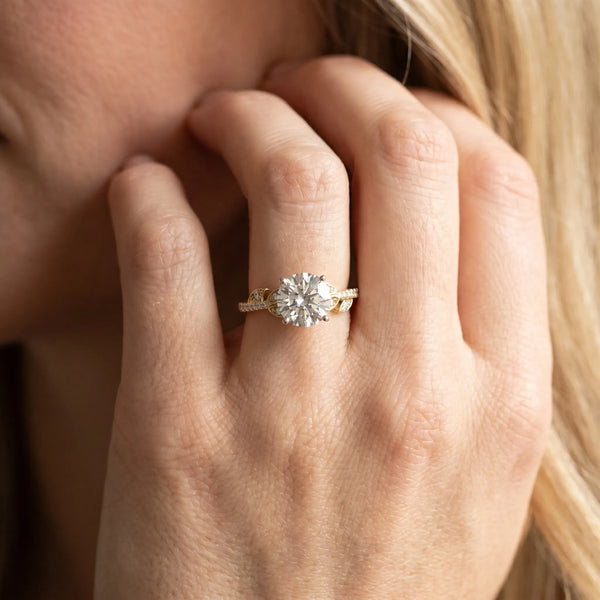 Yellow gold Round Solitaire Leaf-Inspired Diamond Ring with Pavé Band and Four-Prong Setting