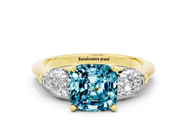 Yellow gold Three-Stone Cushion Cut Blue Topaz Ring with Pear Side Stones and Four-Prong Setting