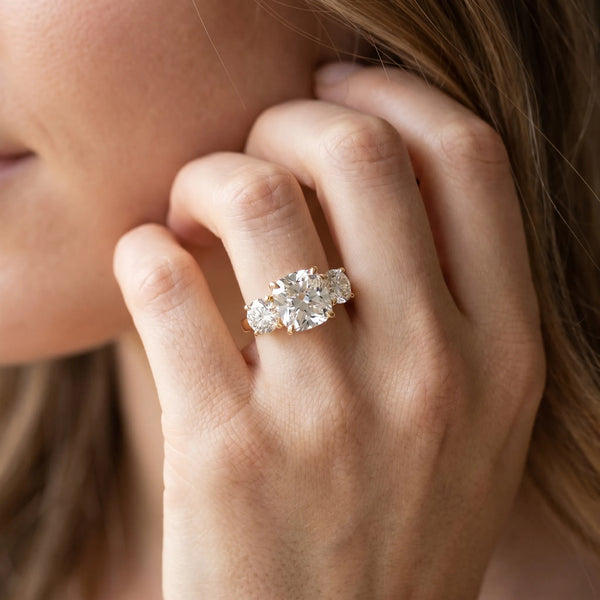 Yellow gold Three-Stone Cushion Cut Diamond Engagement Ring with Prong Setting on a White Gold Band