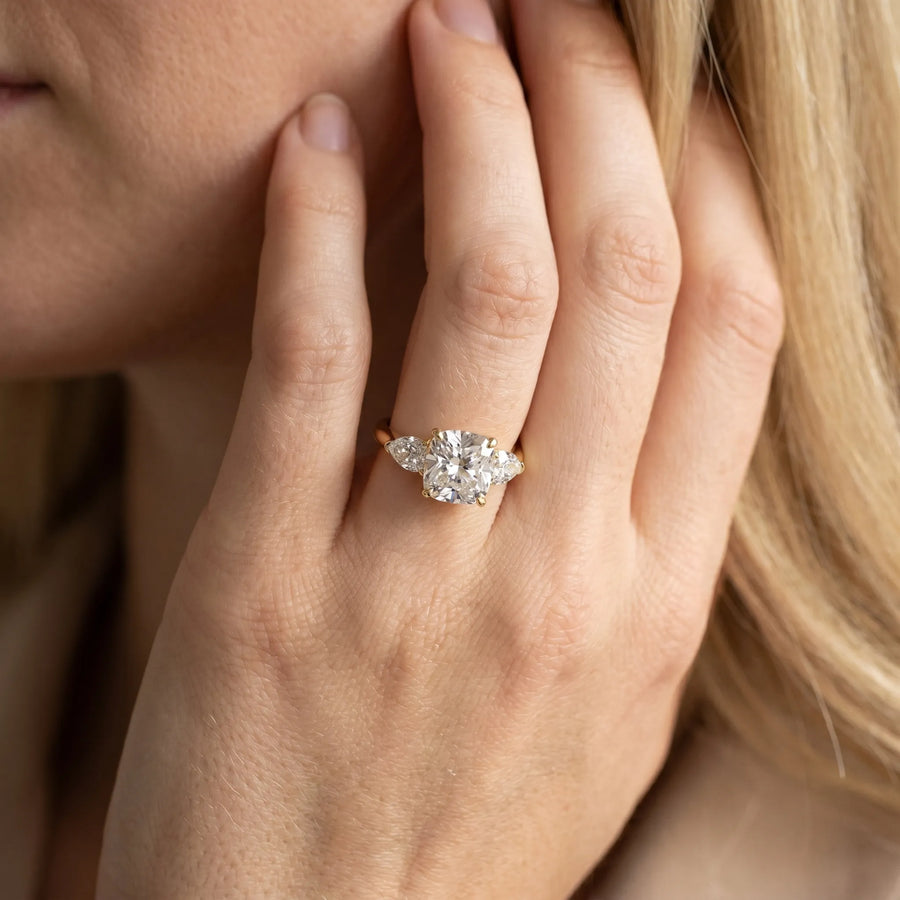 Yellow gold Three-Stone Cushion Cut Diamond Ring with Pear Side Stones and Four-Prong Setting