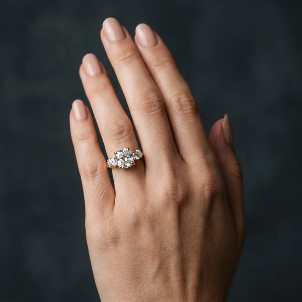 Yellow gold Three-Stone Cushion Cut Diamond Ring with Round Accent Stones, Prong Setting, and Classic Band
