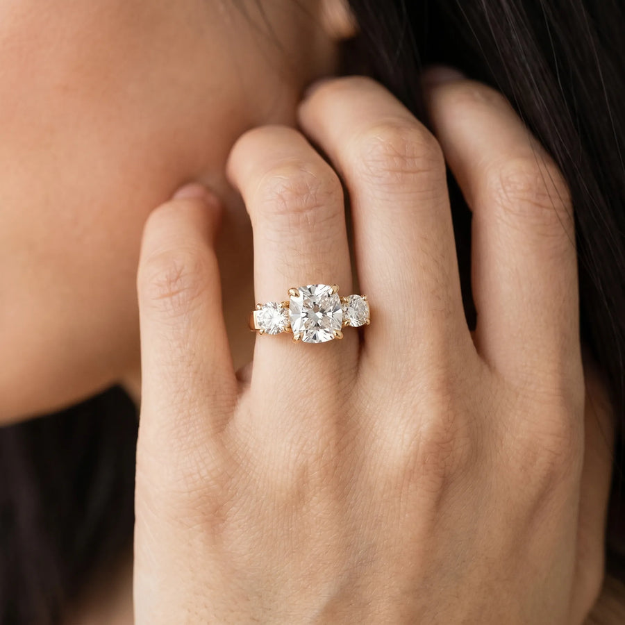 Yellow gold Three-Stone Cushion Cut Diamond Ring with Round Accent Stones, Prong Setting, and Classic Band
