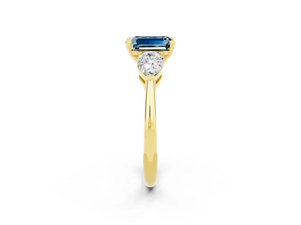 Yellow gold Three-Stone Emerald Cut Aquamarine Ring with Pear Side Stones and Four-Prong Setting