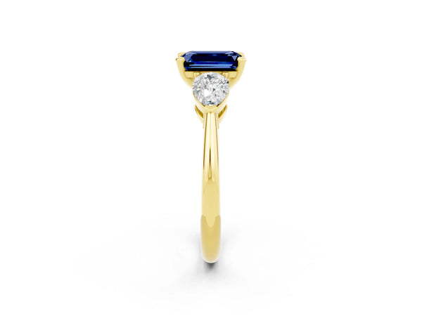 Yellow gold Three-Stone Emerald Cut Blue Sapphire Ring with Pear Side Stones and Four-Prong Setting