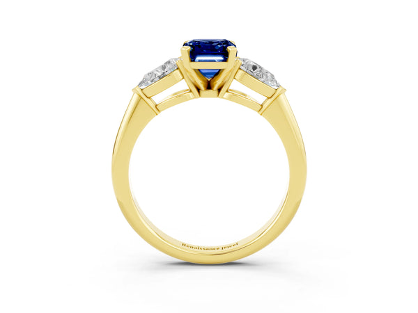 Yellow gold Three-Stone Emerald Cut Blue Sapphire Ring with Pear Side Stones and Four-Prong Setting