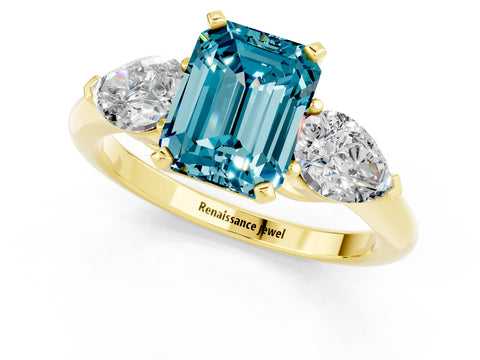 Yellow gold Three-Stone Emerald Cut Blue Topaz Ring with Pear Side Stones and Four-Prong Setting_1