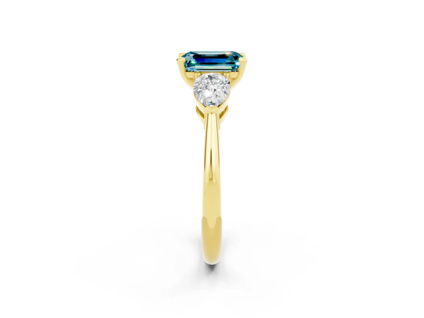 Yellow gold Three-Stone Emerald Cut Blue Topaz Ring with Pear Side Stones and Four-Prong Setting