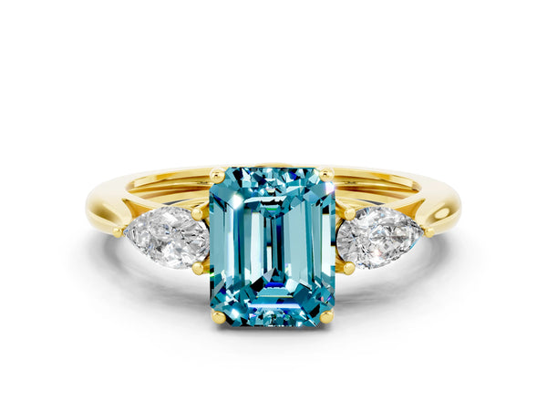 Yellow gold Three-Stone Emerald Cut Blue Topaz Ring with Pear  Side Stones in Four-Prong Setting