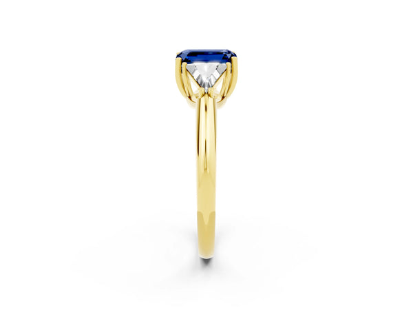 Yellow gold Three-Stone Emerald Cut Blue Sapphire Engagement Ring with Trillion Side Stones and Prong Setting