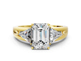 Yellow gold Three-Stone Emerald Cut Cut Diamond Ring with Trillion Side Stones on a Split Shank Band_9