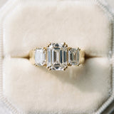 Yellow gold Three-Stone Emerald Cut Diamond Ring with Channel Set Band and Four-Prong Setting_39