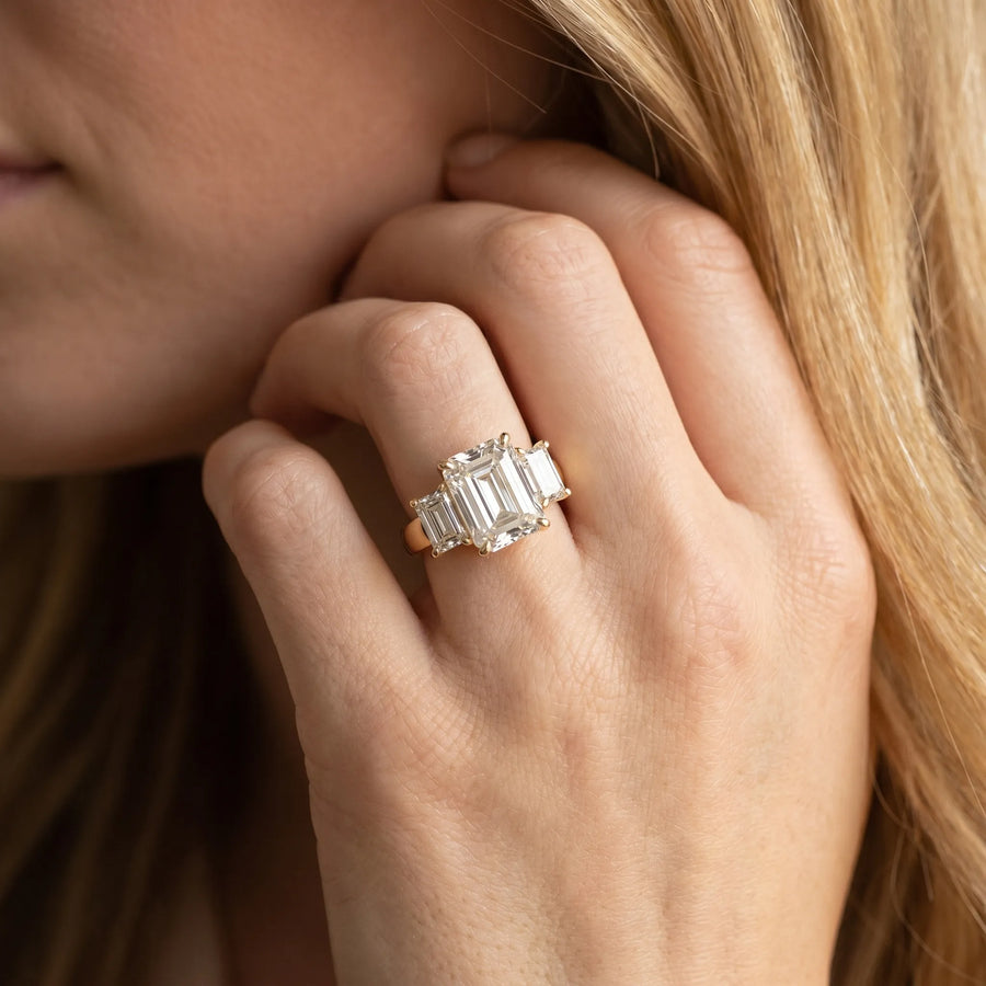 Yellow gold Three-Stone Emerald Cut Diamond Ring with Channel Set Band and Four-Prong Setting
