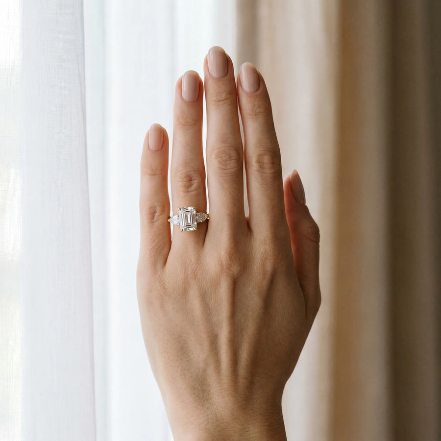 Yellow gold Three-Stone Emerald Cut Diamond Ring with Pear Side Stones and Four-Prong Setting