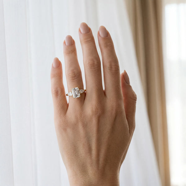 Yellow gold Three-Stone Emerald Cut Diamond Ring with Pear Side Stones in Four-Prong Setting