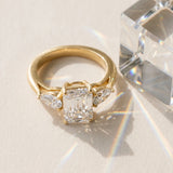Yellow gold Three-Stone Emerald Cut Diamond Ring with Pear Side Stones in Four-Prong Setting_194