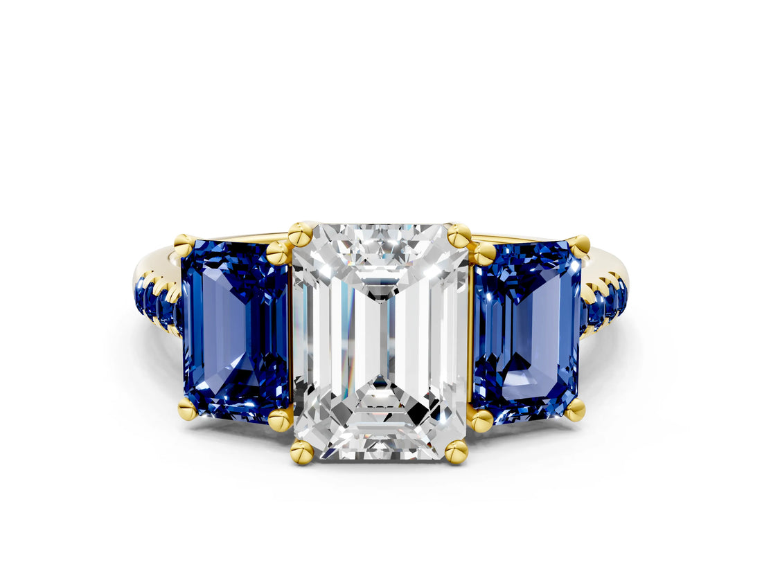 Yellow gold Three-Stone Emerald Cut Diamond Ring with Round with Blue Sapphire side stone Pavé Band and Prong Setting