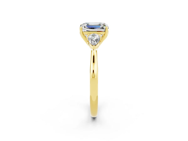 Yellow gold Three-Stone Emerald Cut Moissanite Ring with Pear  Side Stones in Four-Prong Setting
