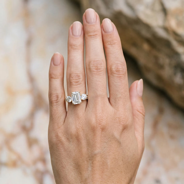 Yellow gold Three-Stone Emerald Diamond Engagement Ring with Prong Setting on a Classic Band