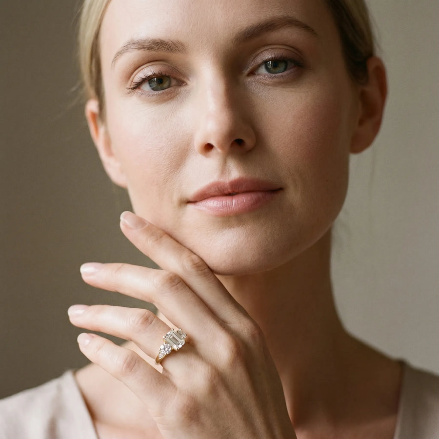 Yellow gold Three-Stone Emerald Diamond Engagement Ring with Prong Setting on a Classic Band